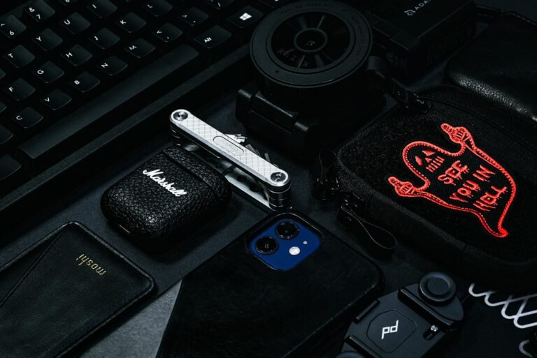 A stylish composition of modern gadgets and accessories including a keyboard, smartphone, and more.