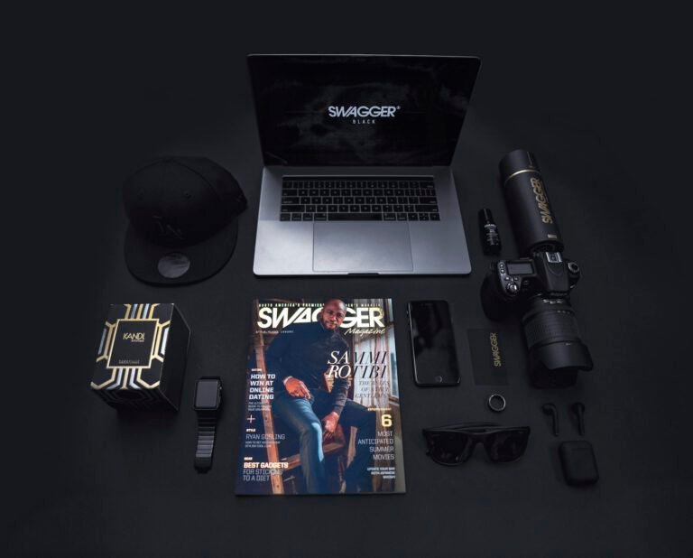 Stylish flat lay featuring technology gadgets and accessories on a dark background.