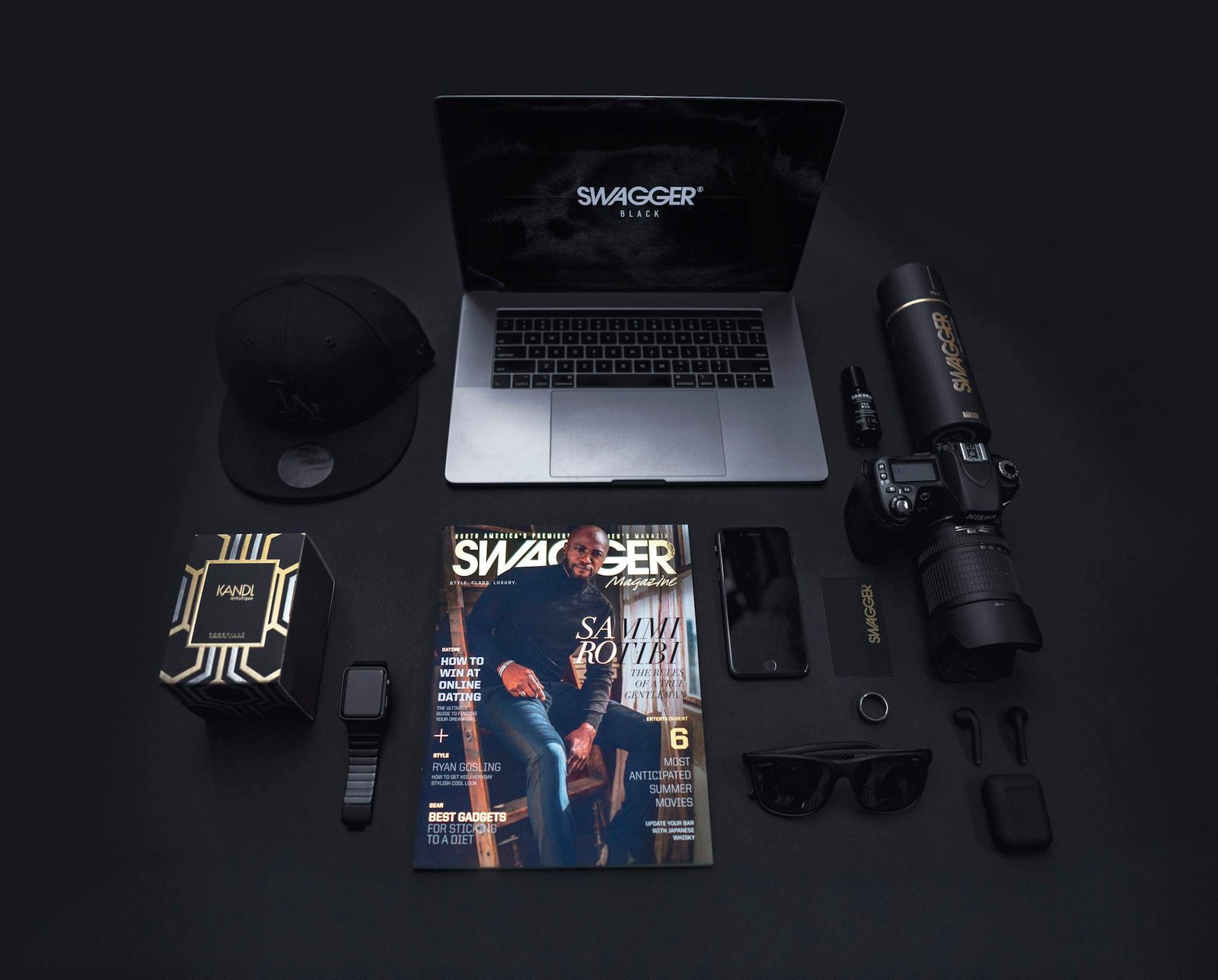 Stylish flat lay featuring technology gadgets and accessories on a dark background.