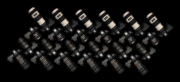 Top view of multiple DSLR cameras with lenses on a black surface. Perfect for tech and photography themes.