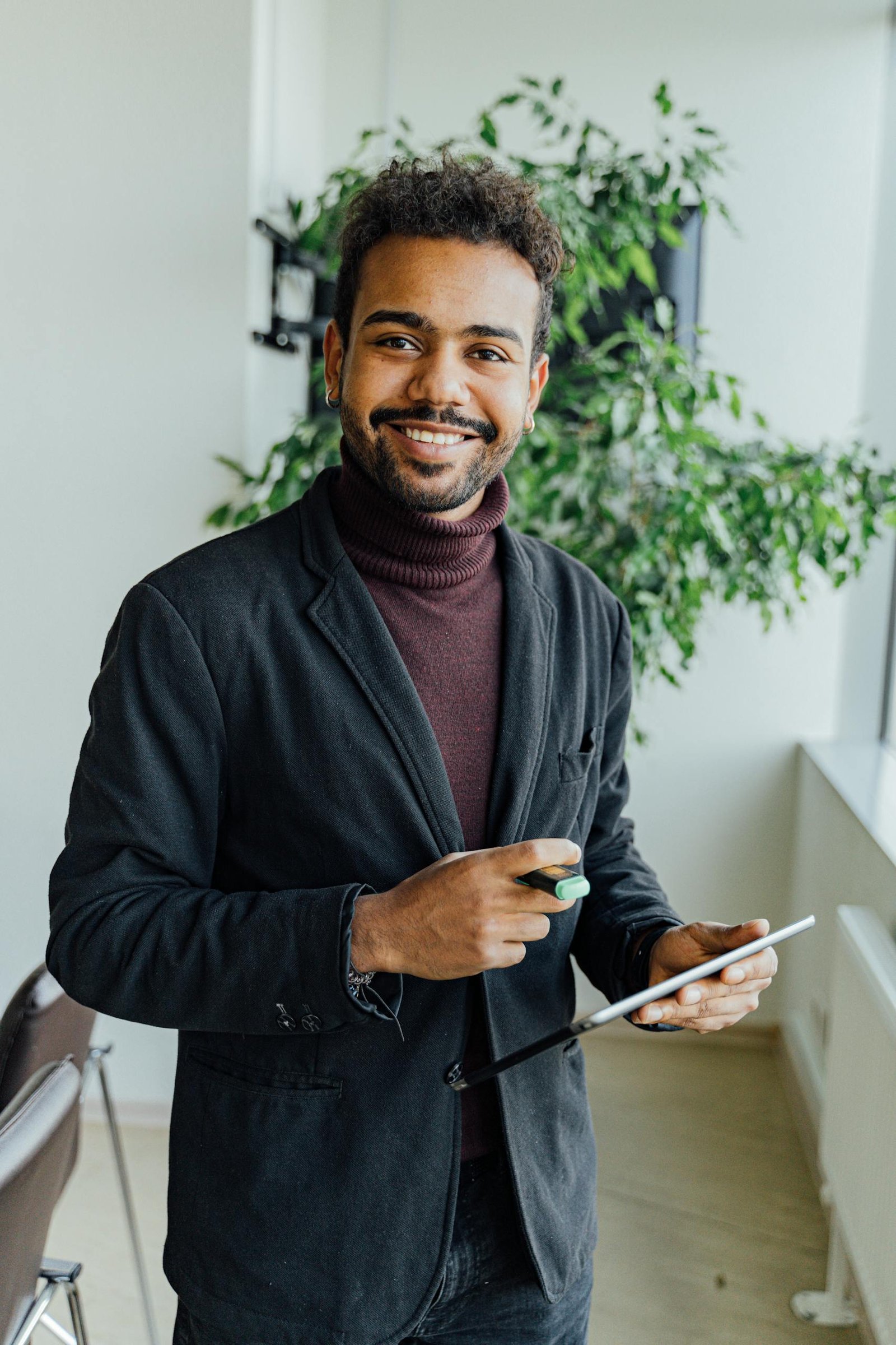 Confident professional using technology in a bright, modern office setting.